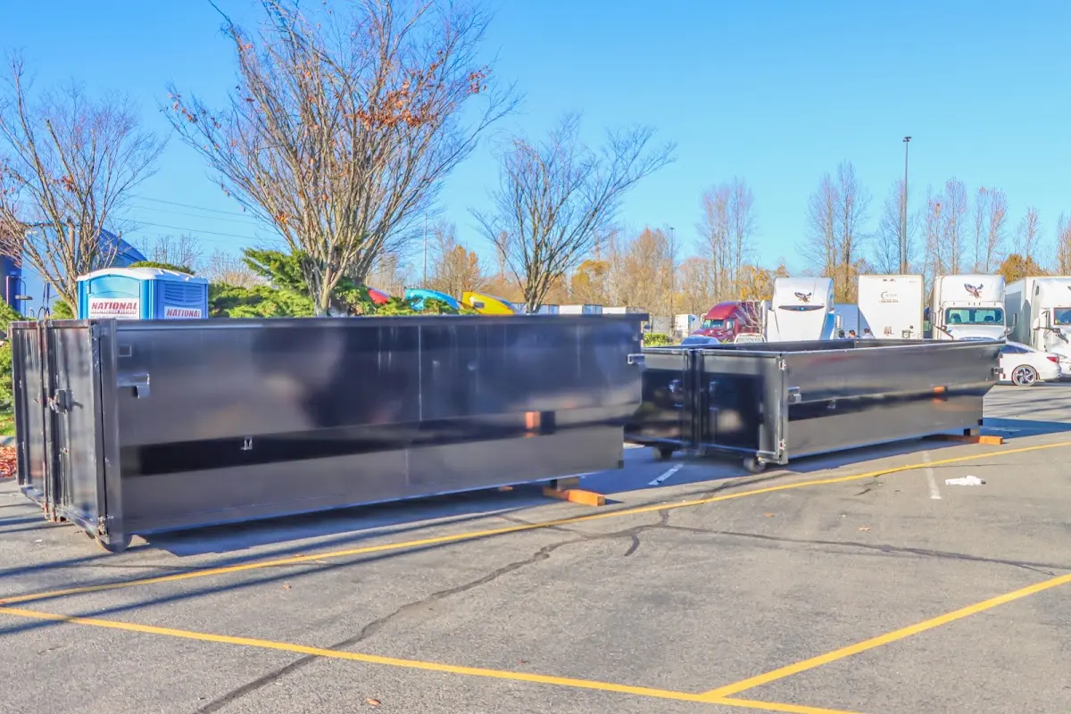 Professional dumpster rental service with roll-off container on residential driveway in Wauconda